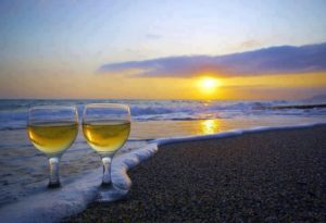 Sun setting on the Ocean with 2 glasses of white wine
