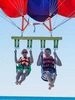 When I went parasailing, it was a dream come true. Two people parasailing.