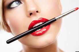 Beauty and Savings. A woman with a cosmetic brush in her teeth.
